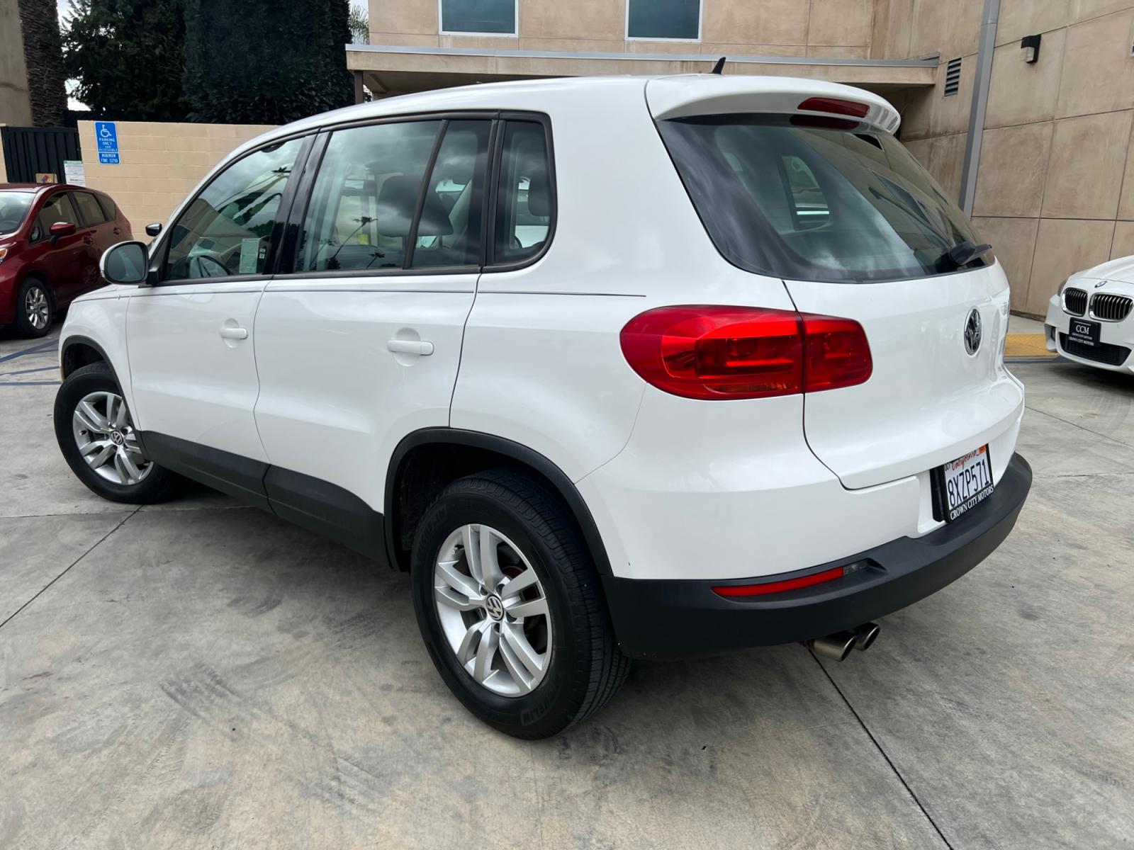 2014 White Volkswagen Tiguan S (WVGAV3AX0EW) with an 2.0L L4 DOHC 16V TURBO engine, AUTOMATIC transmission, located at 30 S. Berkeley Avenue, Pasadena, CA, 91107, (626) 248-7567, 34.145447, -118.109398 - Crown City Motors is a used “Buy Here Pay Here” car dealer in Pasadena CA. “Buy Here Pay Here” financing, means that when you purchase your vehicle from our dealership, that you make the payments to the dealership as well. We do not need the banks approval to get you approved for a used auto - Photo #3