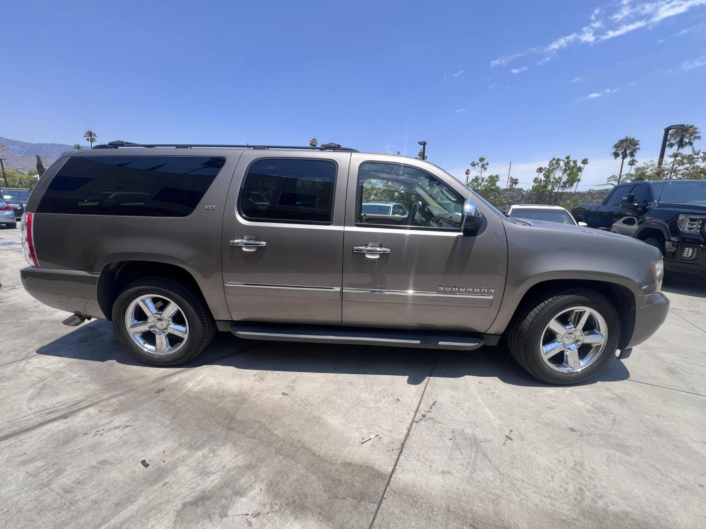 2011 Silver Metallic /Tan Chevrolet Suburban LTZ 1500 4WD (1GNSKKE31BR) with an 5.3L V8 OHV 16V FFV engine, 4-Speed Automatic transmission, located at 30 S. Berkeley Avenue, Pasadena, CA, 91107, (626) 248-7567, 34.145447, -118.109398 - 2011 Chevrolet Suburban LT 4WD – 3rd Row – $995 Down – Buy Here Pay Here – Bad Credit OK – Crown City Motors – Pasadena, CA Looking for a full-size SUV that offers unmatched space, power, and versatility? Look no further than this 2011 Chevrolet Suburban LT 4WD, now available at Crown - Photo#1
