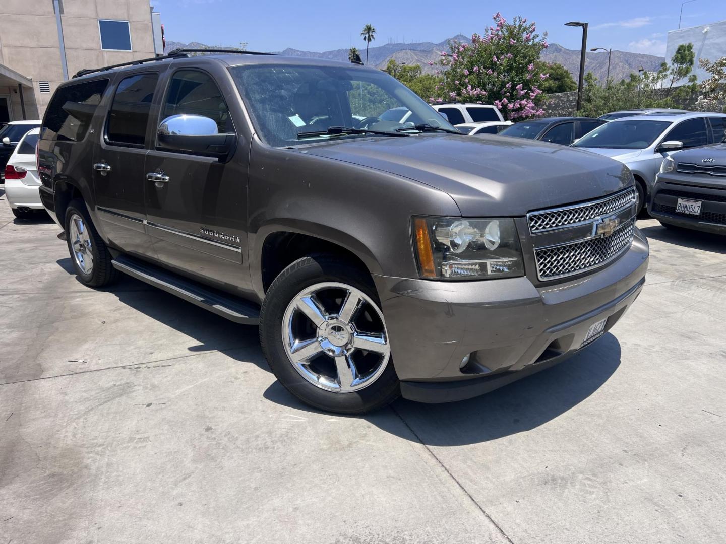 2011 Silver Metallic /Tan Chevrolet Suburban LTZ 1500 4WD (1GNSKKE31BR) with an 5.3L V8 OHV 16V FFV engine, 4-Speed Automatic transmission, located at 30 S. Berkeley Avenue, Pasadena, CA, 91107, (626) 248-7567, 34.145447, -118.109398 - 2011 Chevrolet Suburban LT 4WD – 3rd Row – $995 Down – Buy Here Pay Here – Bad Credit OK – Crown City Motors – Pasadena, CA Looking for a full-size SUV that offers unmatched space, power, and versatility? Look no further than this 2011 Chevrolet Suburban LT 4WD, now available at Crown - Photo#0