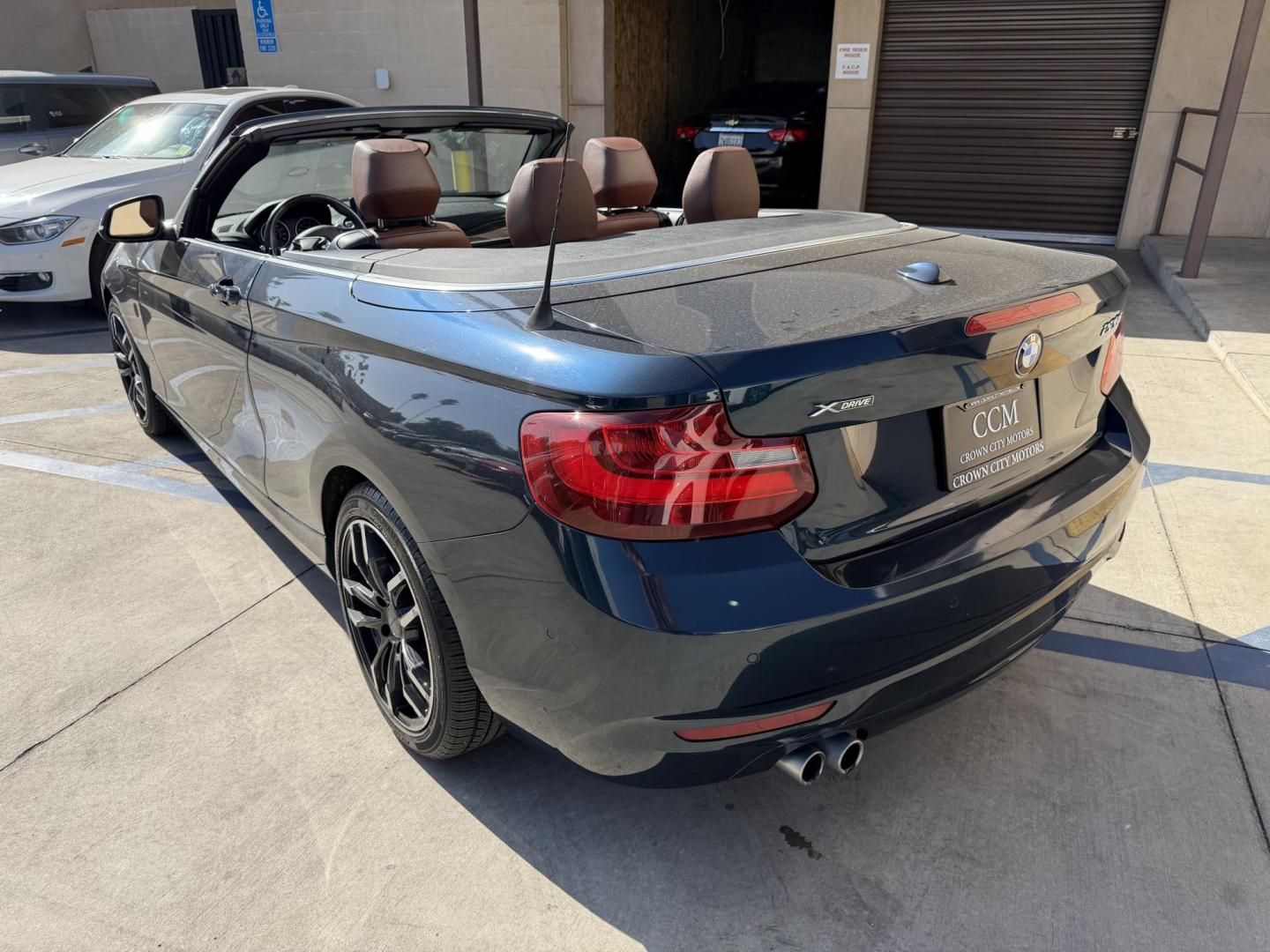 2015 Atlantis Metallic /Black BMW 2-Series 228xi Convertible (WBA1K7C54FV) with an 2.0L L4 DOHC 16V engine, 8A transmission, located at 30 S. Berkeley Avenue, Pasadena, CA, 91107, (626) 248-7567, 34.145447, -118.109398 - 2015 BMW 228i Convertible – Atlantis Metallic | Luxury, Style & Easy Financing in Pasadena Turn heads wherever you go in this stunning 2015 BMW 228i Convertible, finished in rare Atlantis Metallic, a gorgeous blue-green color that shifts beautifully in the sunlight. With its black leather inter - Photo#2